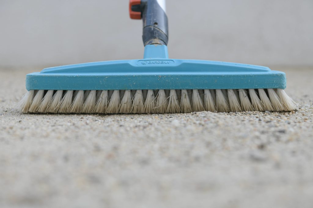 A strong bristle brush is needed to clean the pavers.