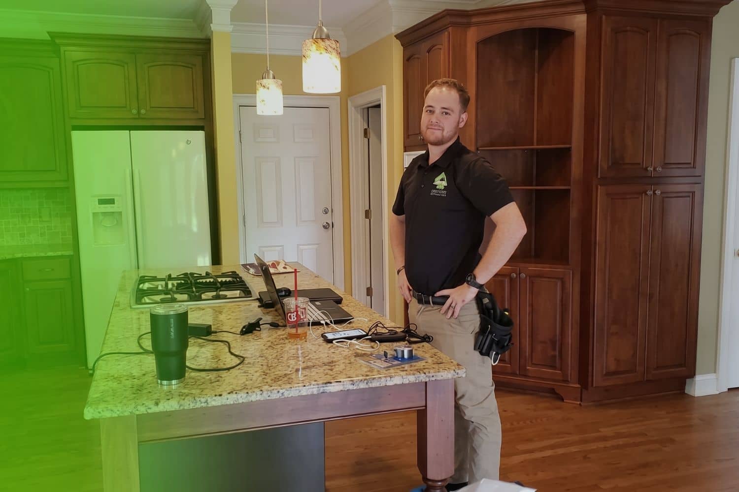 Avalon Home inspector standing next to radon test device placed on kitchen counter during a home inspection in Atlanta GA
