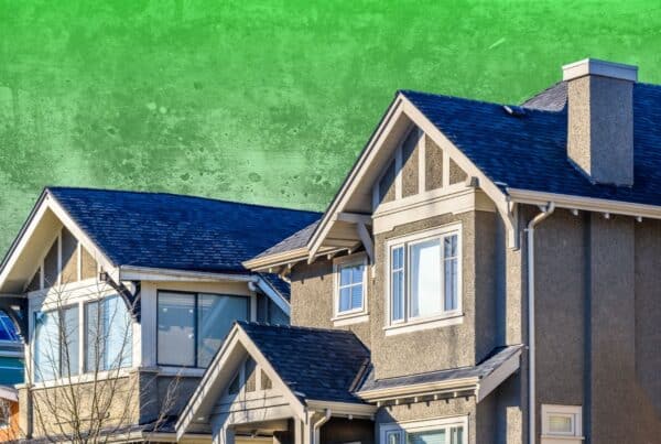 Exterior view of a multi-story modern stucco home set against a textured, mottled bright green background.