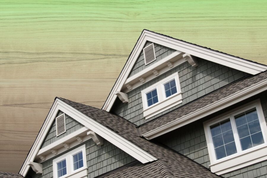 House gables with wood shake siding and asphalt roof shingles set against a natural wood grain textured background.